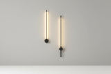 Modern wall lights on a gray wall in a stylish interior setting.