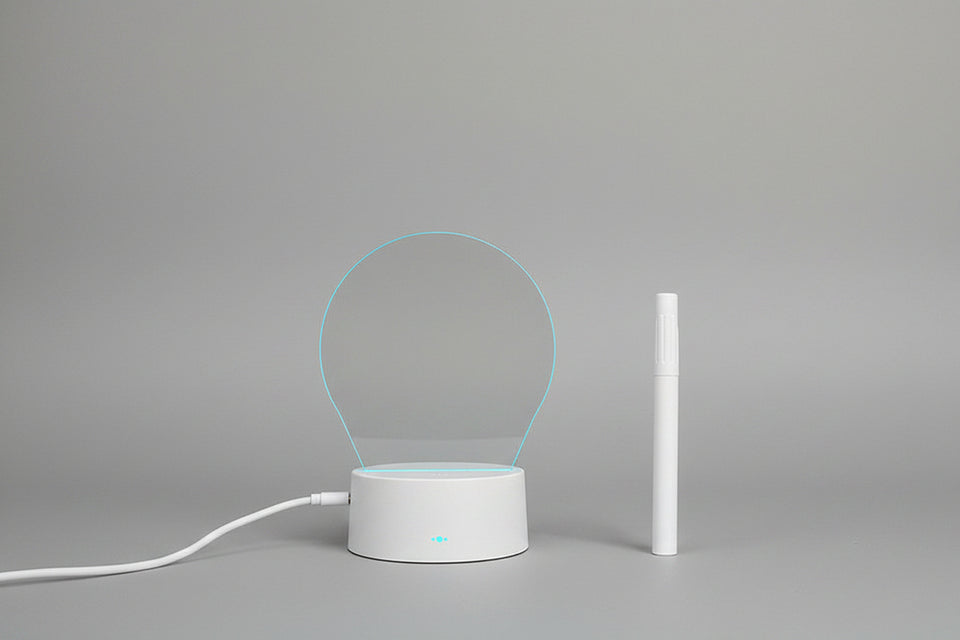 Heart-shaped light projection device on a dark background