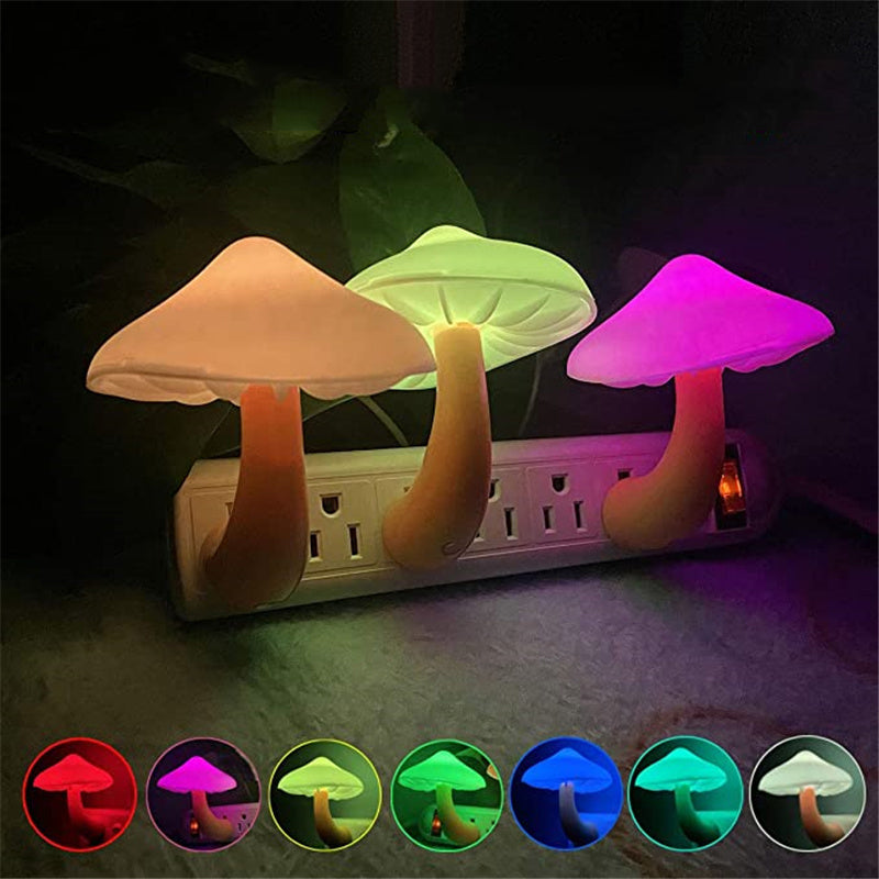 Colorful mushroom-shaped night lights with a power outlet base on a dark background.
