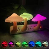 Colorful mushroom-shaped night lights with a power outlet base on a dark background.