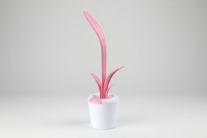 Pink and white cleaning brush with a cylindrical holder on a white background