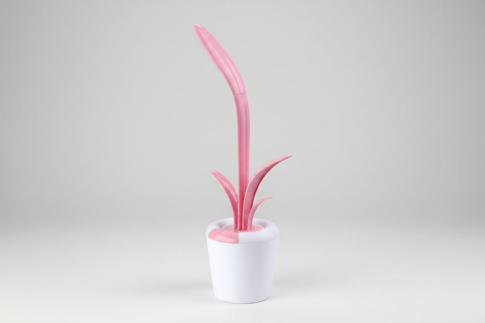 Pink and white cleaning brush with a cylindrical holder on a white background