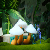 Two cartoon-style mushrooms with a small blue character in a forest setting