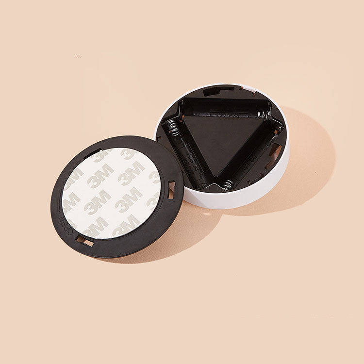 Open black and white container with 3M label on a beige background
